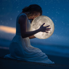 Wall Mural - delicate photography, astrology, women's magic. beautiful attractive girl on a night beach with sand