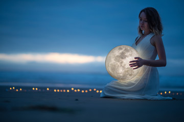 Wall Mural - gentle image of a girl, astrology, female magic. beautiful attractive girl on a night beach with san