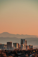 denver skyline against a background of mountains