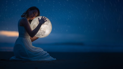 Wall Mural - tender image of a girl; female magic. beautiful attractive girl on a night beach with sand and stars