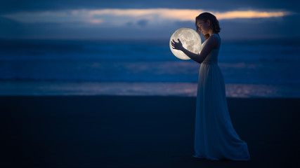 Wall Mural - tender image of a girl. female magic. beautiful attractive girl in full growth on a night beach with