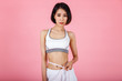 © skarie - Pretty fit woman measuring her waist with a measuring tape. Healthy lifestyles concept.