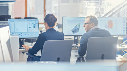 Wall Mural - Back View of Team of Technology Engineers Working on Desktop Computers in Office. Screens Show IDE / CAD Software, Implementation of Machine Learning, Neural Networking and Cloud Computing