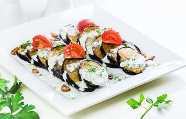 Wall Mural - Grilled slices of eggplant and tomatoes in stack with spicy sauce