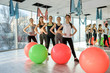 © RomanR - Group of people in gym exercising with fit ball