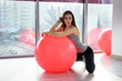 © RomanR - Young and slim fitness instructor posing with big ball