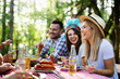 © NDABCREATIVITY - Happy friends enjoying barbecue and grill party outdoor