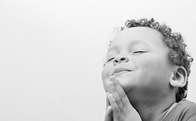 boy praying to God stock image with hands held together on white background stock photo