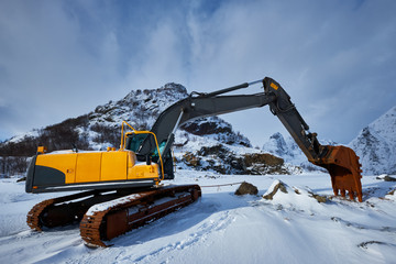 Old excavator in winter