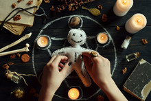 In Voodoo Doll Are Needles Pricked. Candles, Pentagram, Stones, Love Potion And Old Books On Witch Table. Occult, Esoteric Or Divination Concept. Mystic, Halloween And Vintage Background