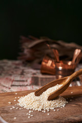 Wall Mural - white sesame seeds on wooden board