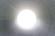 © GENETTICA - Pipe interior leading towards the light. Mock up round frame with gradual depth. Blank background with copy space.