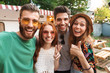 © Drobot Dean - Group of cheerful excited friends standing at the trailer outdoors