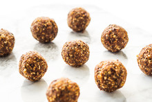 Energy Protein Balls With Healthy Ingredients On Marble Table. Home Made With Dates, Peanut Butter, Flax And Chia Seeds, Oats, Almond And Chocolate Drops. Food Modern Pattern On Marble Table