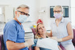 © contrastwerkstatt - Dentist posing with his patient and nurse