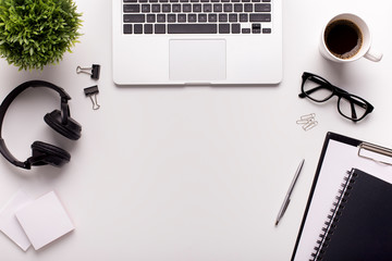 Modern place for work with laptop, headphones and stationery