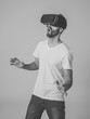 © SB Arts Media - Portrait of excited and amazed young man wearing Virtual Reality headset exploring 3D world