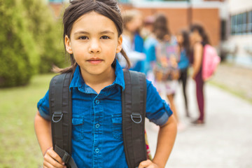 Wall Mural - A student school girl on the playground on the first day of class