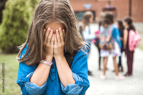 Fotomural A sad Teenage girl outside the school with student on the back