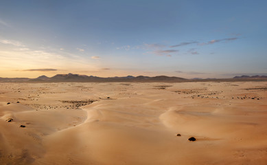 High angle, panoramic view of an empty desert at the sunset with copy space