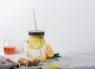 Wall Mural - Ginger Water in Glass jar With Lemon and Honey, Horizontal Orientation, White Background, Copy Space