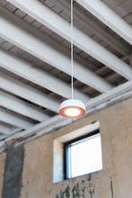 Exposed White Ceiling Beams And Hanging Pendant Light