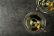 © New Africa - Glasses of Classic Dry Martini with olives on grey table, flat lay. Space for text