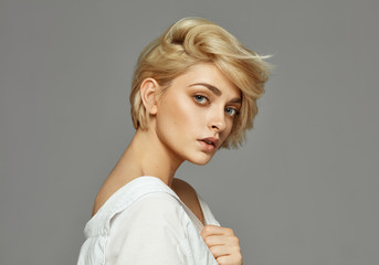 Wall Mural - Portrait of young woman with blond short hair