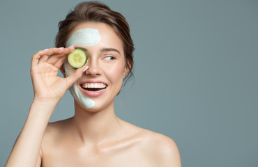 Wall Mural - Portrait of beautiful woman with blue cream mask on her face.