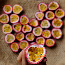 Passion Fruits Cut In Half In Heart Shape Background