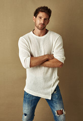 Handsome man in daily casual outfit sitting on chair