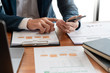 © Pichsakul - strategy analysis concept, Businessman working  financial Manager Researching Process accounting calculate analyse market graph data stock information review on the table in office.