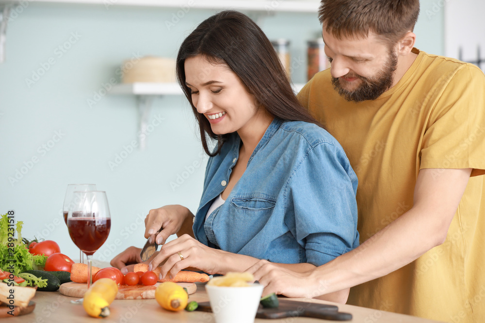 Young couple cooking together in kitchen