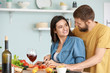 © Pixel-Shot - Young couple cooking together in kitchen