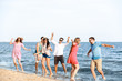 © Pixel-Shot - Happy friends on sea beach at resort