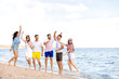 © Pixel-Shot - Happy friends on sea beach at resort