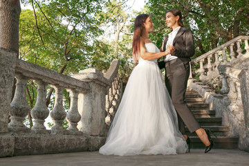 Wall Mural - Beautiful lesbian couple on their wedding day outdoors