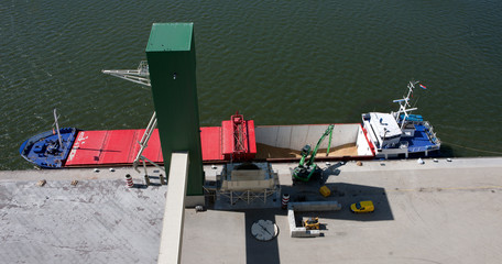 Unloading of ship. Crane. Grain storage Eemsmond Groningen Netherlands. Harbor,