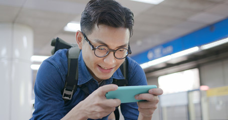 man play games with phone