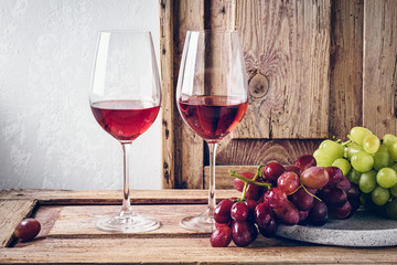 Wall Mural - Two glasses of red wine and grapes.