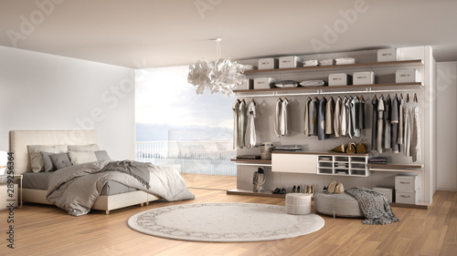 Fotografía Luxury white modern bedroom with double bed and walk-in closet with clothing, pa