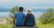 © leungchopan - Couple sit together in the park and look at the landscape