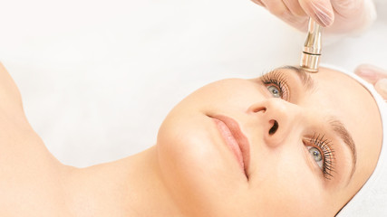 cosmetology face treatment. patient young girl. salon cosmetic hardware. dermatology diamond skin cl