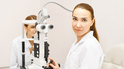 Wall Mural - Eye ophthalmologist exam. Eyesight recovery. Astigmatism check concept. Ophthalmology diagmostic device. Beauty girl portrait in clinic