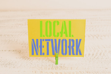 Text sign showing Local Network. Business photo showcasing Intranet LAN Radio Waves DSL Boradband Switch Connection Green clothespin white wood background colored paper reminder office supply