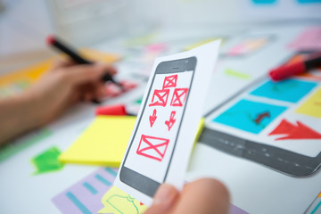 Aufkleber - Web designer is developing an application for mobile phones. Creating a layout of the user interface functions of smartphones. 