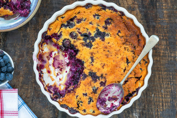 Wall Mural - Lemon, blueberry and blackberry clafoutis - delicious baked fruit dessert - overhead view