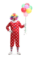 Wall Mural - Cheerful clown holding a bunch of balloons