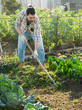 © JackF - Man raking grass in homestead