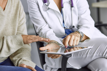 female doctor talking to a patient on a tablet